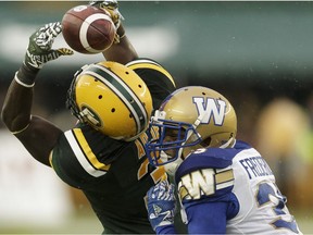 Edmonton's Natey Adjel (3) misses a catch as Winnipeg's Terrence Frederick (35) chases during the first half of a CFL football game between the Edmonton Eskimos and the Winnipeg Blue Bombers at Commonwealth Stadium in Edmonton, on Thursday, July 28, 2016.