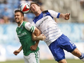 Edmonton's Albert Watson (5) and New York's Hunter Freeman (2) collide while heading the ball during a NASL soccer game between FC Edmonton and the New York Cosmos at Clarke Stadium in Edmonton, Alta., on Sunday May 15, 2016. Photo by Ian Kucerak