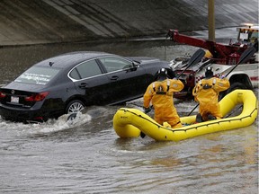 Firefighters had to perform a water rescue on Whitemud Drive under 111 Street early Saturday evening as heavy rains in the Edmonton area caused flooding in the region.