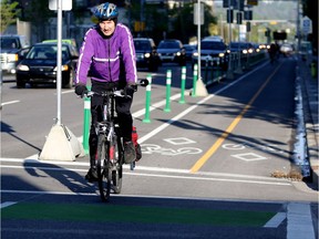 Bill Cozens uses a segregated bike lane  on his morning commute to work in Calgary on June 4, 2015.