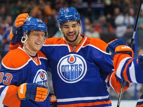 Mark Fraser and Ales Hemsky celebrate an Edmonton Oilers goal.