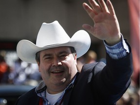 Conservative MP Jason Kenney waves to the crowd during the Calgary Stampede parade on July 8, 2016. Former PM Stephen Harper has endorsed Kenney's Alberta PC leadership bid.