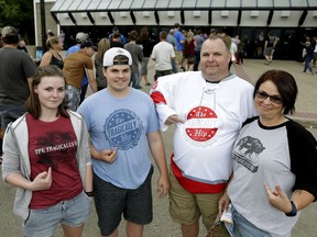 Jeff and Michelle Patrick and their children Madyson and Noah line up to attend The Tragically Hip on Thursday July 28, 2016.