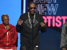 From left, Jermaine Dupri, Snoop Dogg and Birdman present the award for best new artist at the BET Awards at the Microsoft Theater on Sunday, June 26, 2016, in Los Angeles.