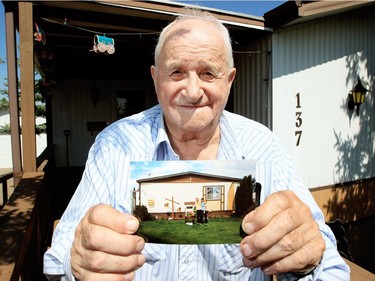 Joe Jaksitz, 87, displays a 1987 photo of his home at the Evergreen mobile home park that was damaged in the tornado that hit the mobile home park in north east Edmonton, Monday July 30, 2012.