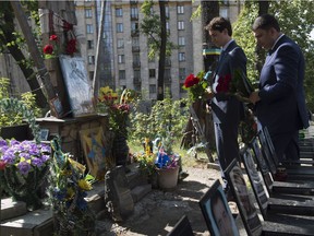 Prime Minister Justin Trudeau, left, and Ukranian Prime Minister Volodymyr Groysman lay flowers at a tribute to Ukrainians killed during the uprising in Kyiv, Monday July 11, 2016.