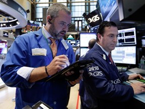 Trader Kevin Lodewick, left, and specialist John Sciulli work on the floor of the New York Stock Exchange on July 27, 2016.