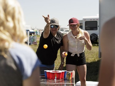 (Left to right) Ally Smyth, Layton Girodat, Ashley Keith and Logan Elder from Hanna, Alta., play beer pong during Big Valley Jamboree 2016 in Camrose, Alberta on Friday, July 29, 2016.