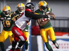 Edmonton Eskimos' Cedric McKinley, right, breaks a tackle by Calgary Stampeders' Maleki Harris during first half CFL pre-season football action in Calgary, Saturday, June 11, 2016.THE CANADIAN PRESS/Jeff McIntosh ORG XMIT: JMC105