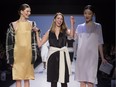 Designer Malorie Urbanovitch, centre, flanked by models at Toronto Fashion Week, Oct. 22, 2013.