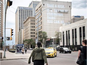 Final touches are put on the Melcor's 100 Street Place building. Created and installed by local designer Clay Lowe, it reads, "Take a risk. It's the most Edmonton thing you can do."