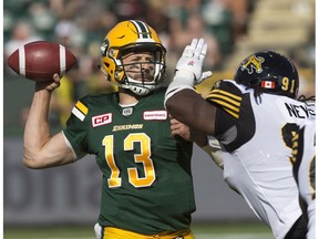 Edmonton Eskimos quarterback Mike Reilly attempts a pass against the Hamilton Tiger-Cats during first half CFL action in Edmonton, Alta., on Saturday July 23, 2016. The Eskimos lost 37-31.
