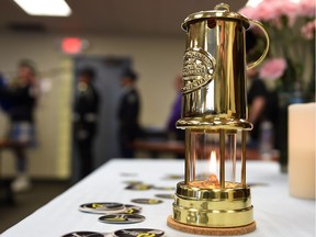 A miner's lamp burns during the International Day of Mourning Ceremony for workers killed and injured on the job, at AUPE offices in Edmonton Apr. 28, 2015. Alberta's auditor general said in his July 5, 2016, report that the Labour department must do more to make sure processes are in place to keep Alberta workers safe.