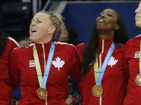 Canada's Natalie Achonwa, from left, Lizanne Murphy, Tamara Tatham and Katherine Plouffe sing the Canada national anthem during the women's basketball medal ceremony at the Pan Am Games, Monday, July 20, 2015, in Toronto.