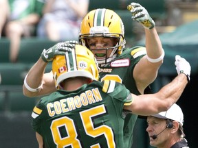 Edmonton Eskimos' Nate Coehoorn (85) and Chris Getzlaf (89) celebrate a touchdown against the Saskatchewan Roughriders during first half CFL pre-season action in Edmonton, Alta., on Saturday June 18, 2016.