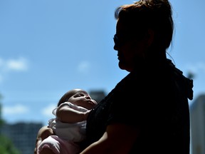 "Jenny," who's name has been changed to protect the identity of her two children in government care, was supported by the Healthy, Empowered, and Resilient Pregnancy Program during her third pregnancy. She is now successfully caring for two-month old Britney. Photographed July 18, 2016.