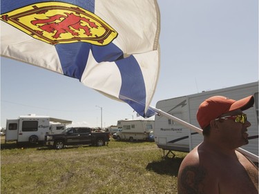 Nova Scotian Graham McKeen flies his province's flag proudly during Big Valley Jamboree 2016 in Camrose, Alberta on Friday, July 29, 2016.