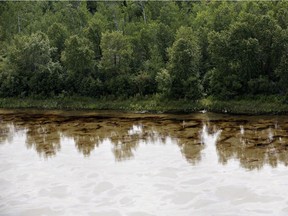 An oil slicks floats on the North Saskatchewan river near Maidstone, Sask on Friday July 22, 2016. Husky Energy has said between 200,000 and 250,000 litres of oil and other material leaked into the river on Thursday from its pipeline.