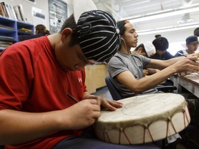 Mathayio Grey, 14, paints a drum during class at Oskayak Police Academy held at Amiskwaciy Academy in Edmonton, on Thursday, July 14, 2016. Students learn about policing and First Nations culture for two weeks of summer classes.