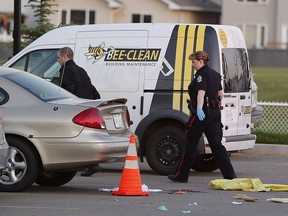 Police investigate the scene of a shooting at 436 Brintnell Blvd. on Saturday, July 23, 2016 in Edmonton. Two men have been charged with first-degree murder.