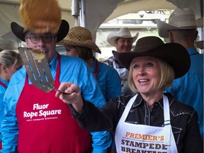 Alberta Premier Rachel Notley flips pancakes at the annual Premier's Stampede Breakfast in Calgary on July 11, 2016.