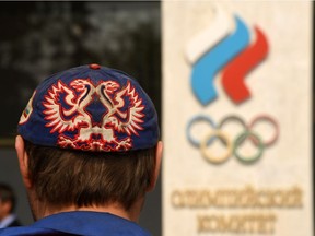 A man walks in front of the Russian Olympic Committee (ROC) building in Moscow on July 25, 2016. Russia breathed a sigh of relief after the IOC declined to impose a blanket ban on its competitors at the Rio Games over state-run doping, but the decision met fierce criticism elsewhere with Olympic chiefs branded "spineless". In one of the most momentous moves in its chequered history, the International Olympic Committee said on July 24, 2016, it was up to each international sports federation to decide if Russians could take part in Rio.