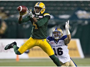 Winnipeg Blue Bombers' Taylor Loffler (16) chases Edmonton Eskimos' Adarius Bowman (4) as he makes the catch during second half CFL action in Edmonton, Alta., on Thursday July 28, 2016.