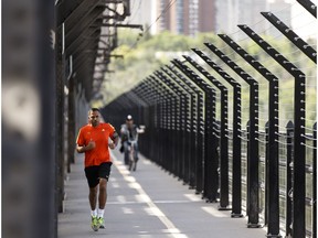 A runner crosses the west sidewalk of the High Level Bridge in Edmonton, Alta., on Thursday June 16, 2016.