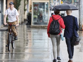 Edmontonians walk and cycle in the rain.