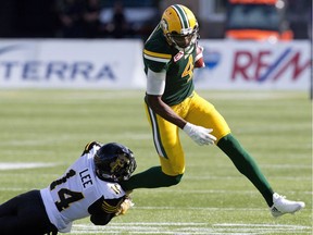 Hamilton Tiger-Cats' Travis Lee (14) misses the tackle on Edmonton Eskimos' Adarius Bowman (4) during first half CFL action in Edmonton, Alta., on Saturday July 23, 2016.