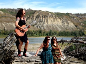Jody Peck (left), also known as Miss Quincy, performs on the banks of the Peace River with the band Twin Peaks. The performance is part of My Peace River.