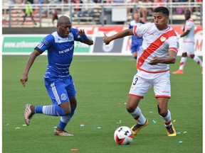 FC Edmonton midfielder Sainey Nyassi challenges Rayo OKC defender Moises Hernandez for the ball Saturday, July 2, 2016 in North American Soccer League play in Oklahoma City. The game ended in a 1-1 tie.