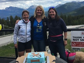 Celebrating at Jasper's Marmot Basin Ski Resort after a 900-km bike are from left; Susan Agrios; Nadine Samycia, CASA Foundation executive director, and supporter Jenn Cranston, who made a celebratory cake complete with the ride's butterfly logo.
