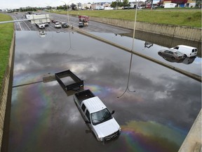 Vehicles and people were flooded under the 106 Street overpass on the Whitemud Drive and had to be rescued by the fire department on Wednesday, July 27, 2016.