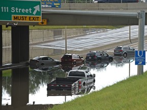 Vehicles and people were flooded under the 106 St. over pass on the Whitemud Dr. and had to be rescued by the fire dept. in Edmonton Wednesday, July 27, 2016.  Ed Kaiser/Postmedia (Standalone Photo)