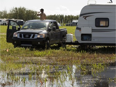 Water floods a campsite after rain on July 28 during Big Valley Jamboree 2016 in Camrose, Alberta on Friday, July 29, 2016.