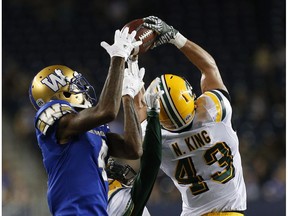 Edmonton Eskimos' Neil King (43) intercepts the pass intended for Winnipeg Blue Bombers' Darvin Adams (4) late in the second half of CFL action in Winnipeg Thursday, July 14, 2016.