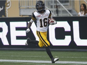 Hamilton Tiger-Cats' Brandon Banks (16) runs in the punt return for the touchdown against the Winnipeg Blue Bombers during the first half of CFL action in Winnipeg Thursday, July 2, 2015.