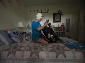 Competitive swimmer andOlympic hopeful Adelaide McKenzie, 10, packs her swim bag in her bedroom in Edmonton on Friday Aug. 12, 2016.