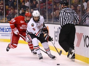 Matt Benning #5 of the Northeastern Huskies skates against J.J. Piccinich of the Boston University Terriers during the second period of the 2015 Beanpot Tournament Championship game at TD Garden on February 23, 2015 in Boston, Massachusetts.