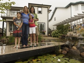 The Tse family, including (left to right) Cole, 11, Caley, Ellia, 9, and Desmond pose with their backyard garden pond, part of the 2016 Parade of Ponds Tour, taking place August 13-14.