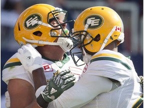 Edmonton Eskimos wide receiver Nate Coehoorn, left, celebrates scoring a touchdown with slotback Adarius Bowman during first half CFL football action in Toronto on Saturday, August 20, 2016.