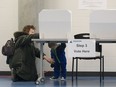 Genowefa Bernat collects her grandson Zach Bernat, 1, after casting her ballot in the civic by-election advance polls on Feb. 8, 2016.