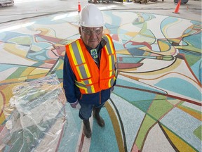 Alex Janvier standing on his artwork: Tsa Tsa Ke K'e (Iron Foot Place) in Ford Hall in Rogers Place.