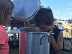 Blayke Coldwell and Brooke Nehring, both 6, disappointedly look into empty pots that were supposed to have fresh lobster cooking on Aug. 13, 2016.