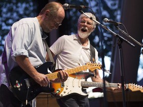 Paul Barrere, left, and Fred Tackett perform during the opening night of the Edmonton Blues Festival in Hawrelak Park, in Edmonton on Friday Aug. 19, 2016.