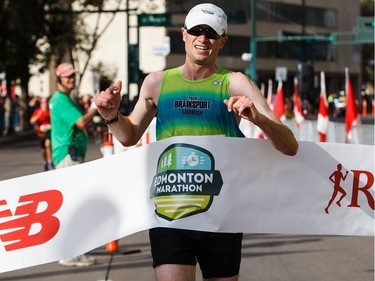 Brendan Lunty breaks the tape as winner of the men's event at the 2016 Edmonton Marathon on Sunday, Aug. 21, 2016.