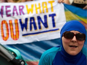 A woman wearing a burkini joins a protest outside the French Embassy in London on Aug. 25, 2016, during a "Wear what you want beach party" to demonstrate against the ban on burkinis on French beaches and to show solidarity with Muslim women.