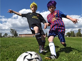 Brothers Tomas (left), 10, and Peiter, 9, Thorup play soccer.