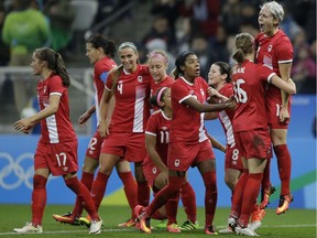 Canada's Sophie Schmidt, right, celebrates after scoring her team's first goal during a quarter-final match of the women's Olympic football tournament between Canada and France in Sao Paulo, Brazil, Aug. 12, 2016.